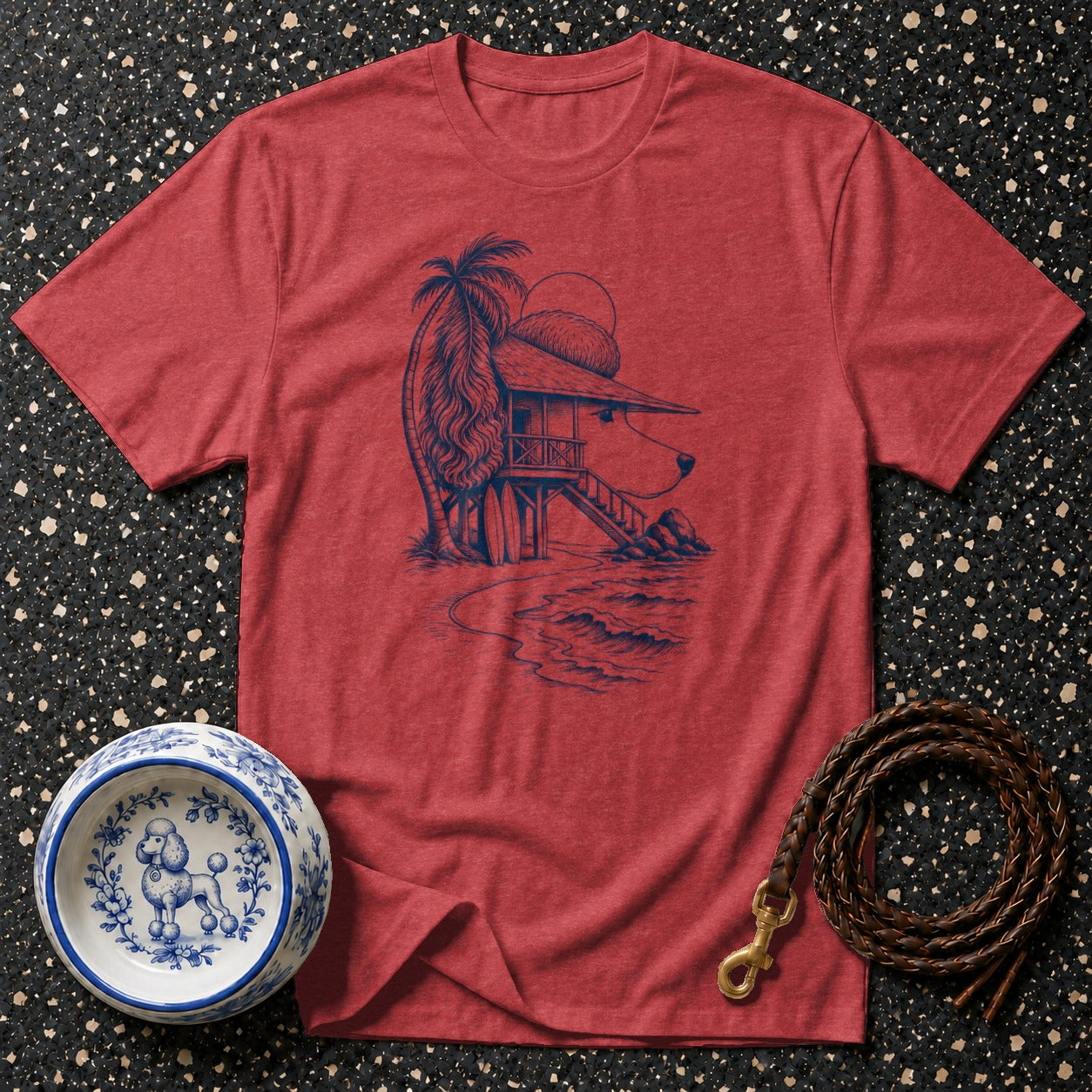 Red t-shirt with a sketch of a dog-shaped beach house, palm tree, and ocean.