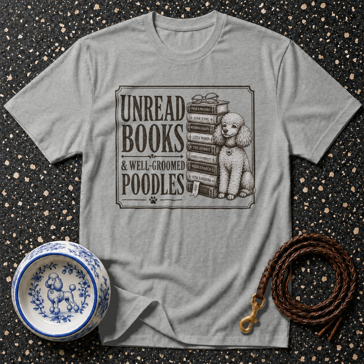 T-shirt with "Unread Books & Well-Groomed Poodles" and dog on books.