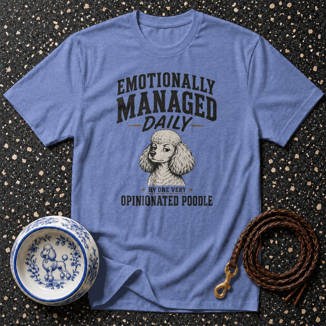 Blue t-shirt with poodle illustration and text "Emotionally Managed Daily By One Very Opinionated Poodle".