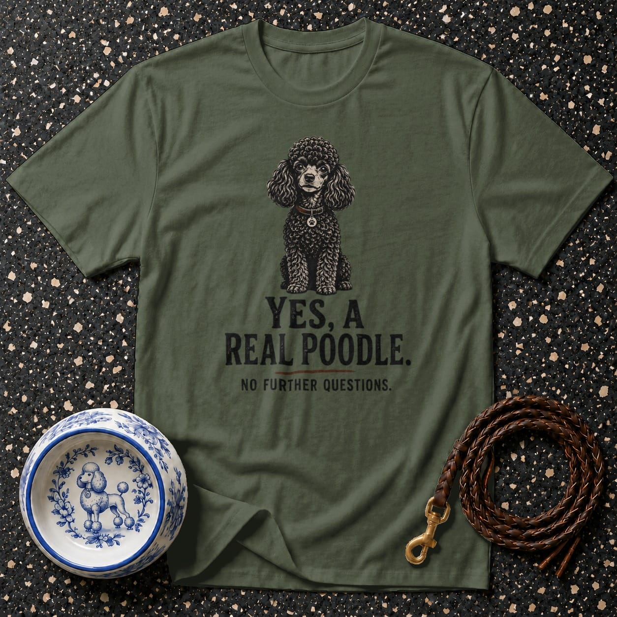Olive green t-shirt with a black poodle illustration and text "YES, A REAL POODLE."