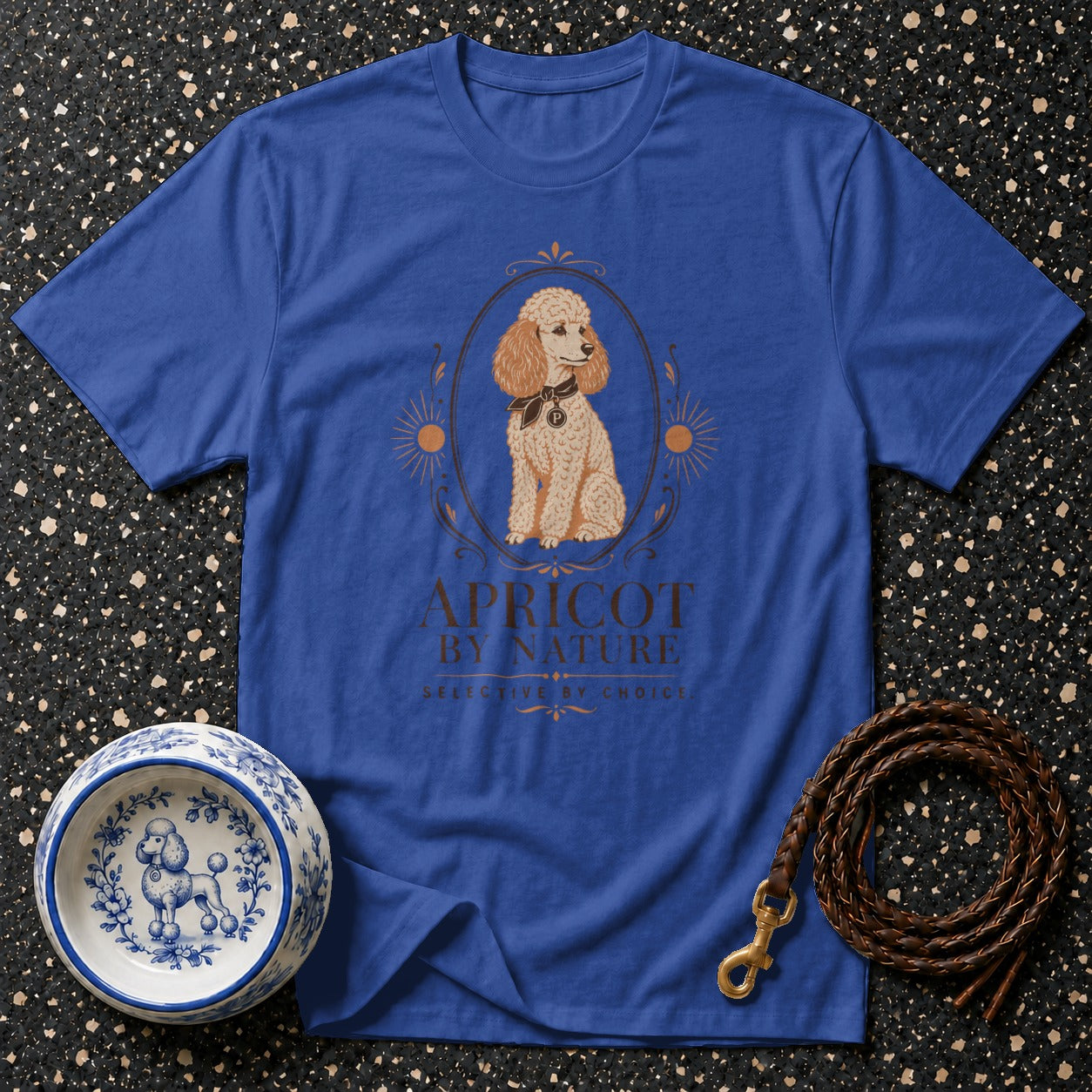 Blue t-shirt featuring a poodle illustration with text "APRICOT BY NATURE".
