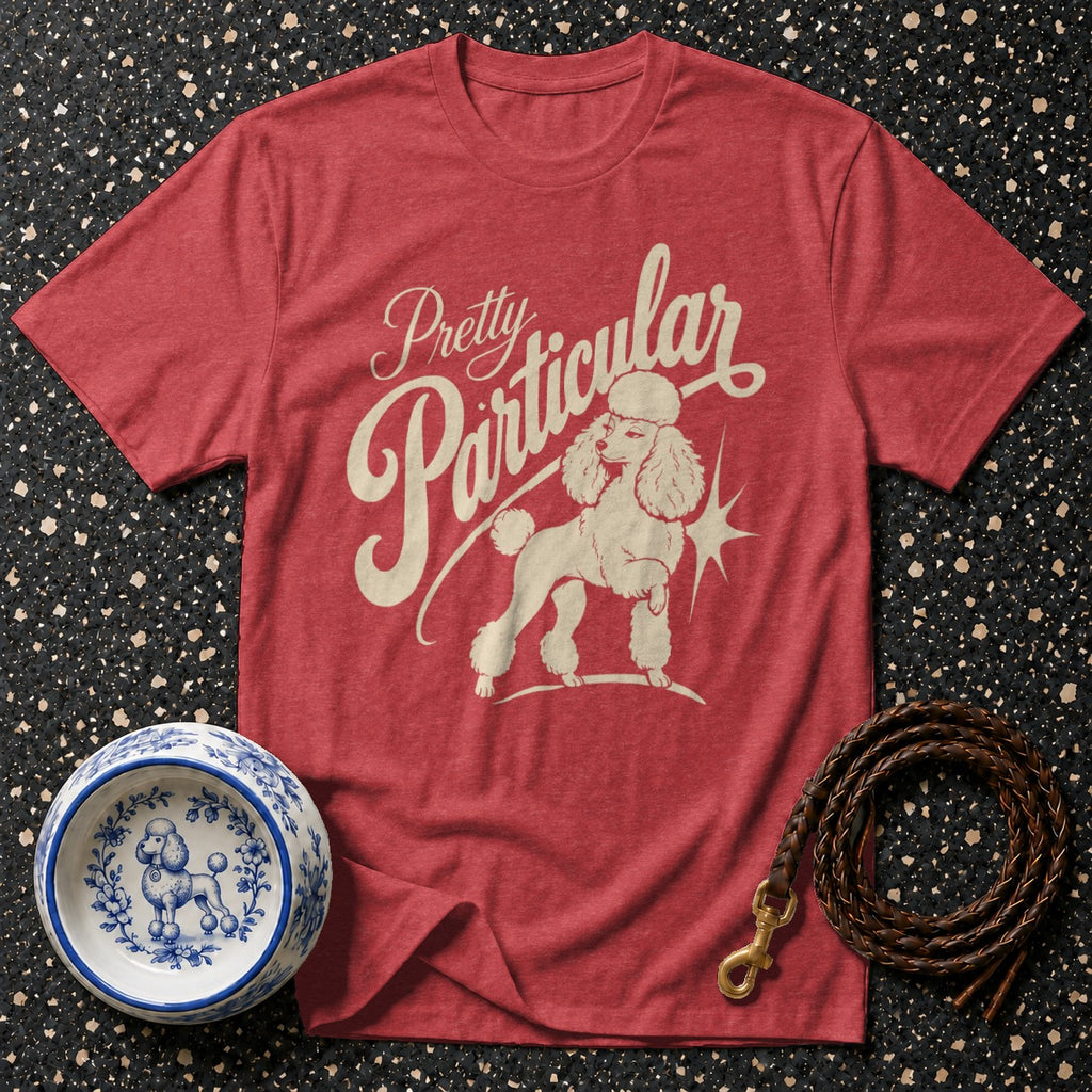 Red t-shirt with cream poodle graphic and "Pretty Particular" text.