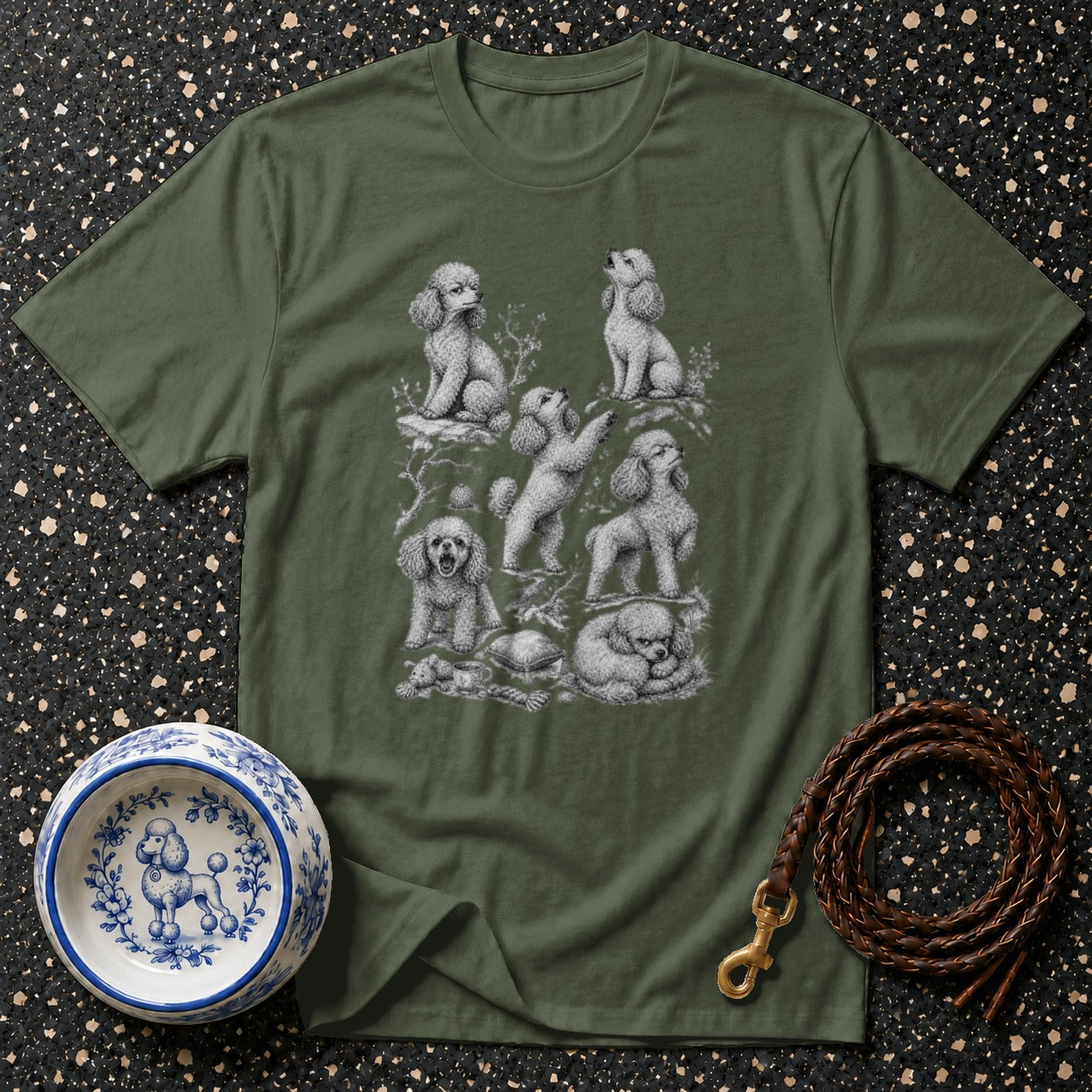 Green t-shirt with a detailed illustration of seven poodles in various poses.