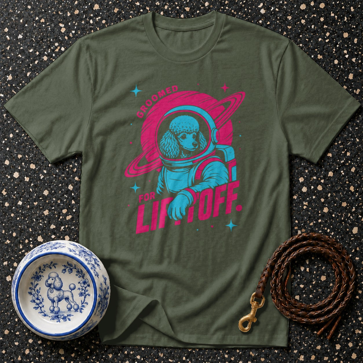 Green t-shirt with poodle astronaut graphic and text "GROOMED FOR LIFTOFF".