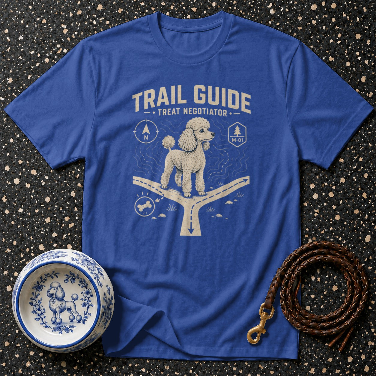 Blue t-shirt with white "Trail Guide Treat Negotiator" graphic of a poodle at a crossroads.