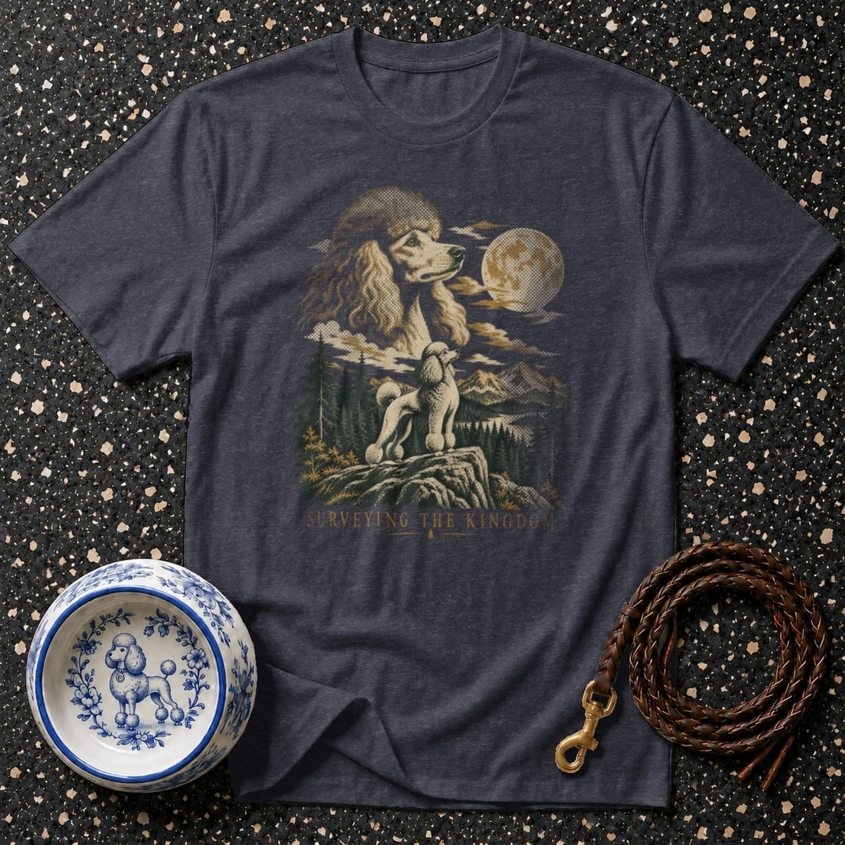 Dark t-shirt with a poodle graphic, text "SURVEYING THE KINGDOM," and decorative dog bowl.