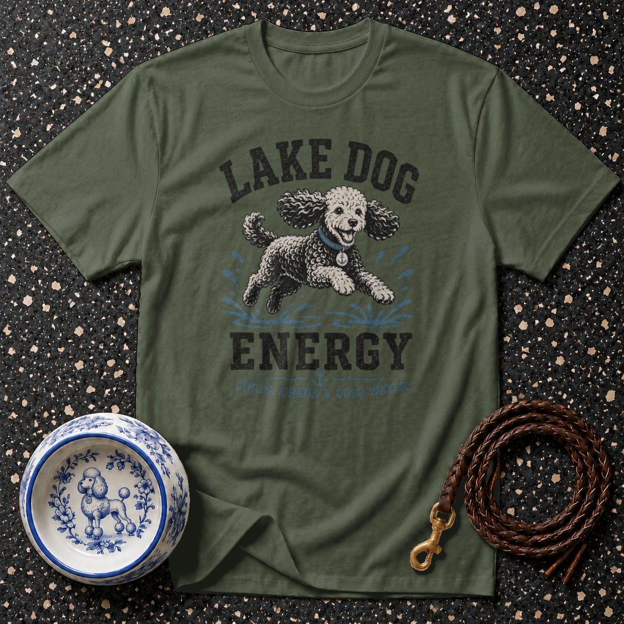 Green t-shirt with "Lake Dog Energy" graphic of a poodle playing in water.