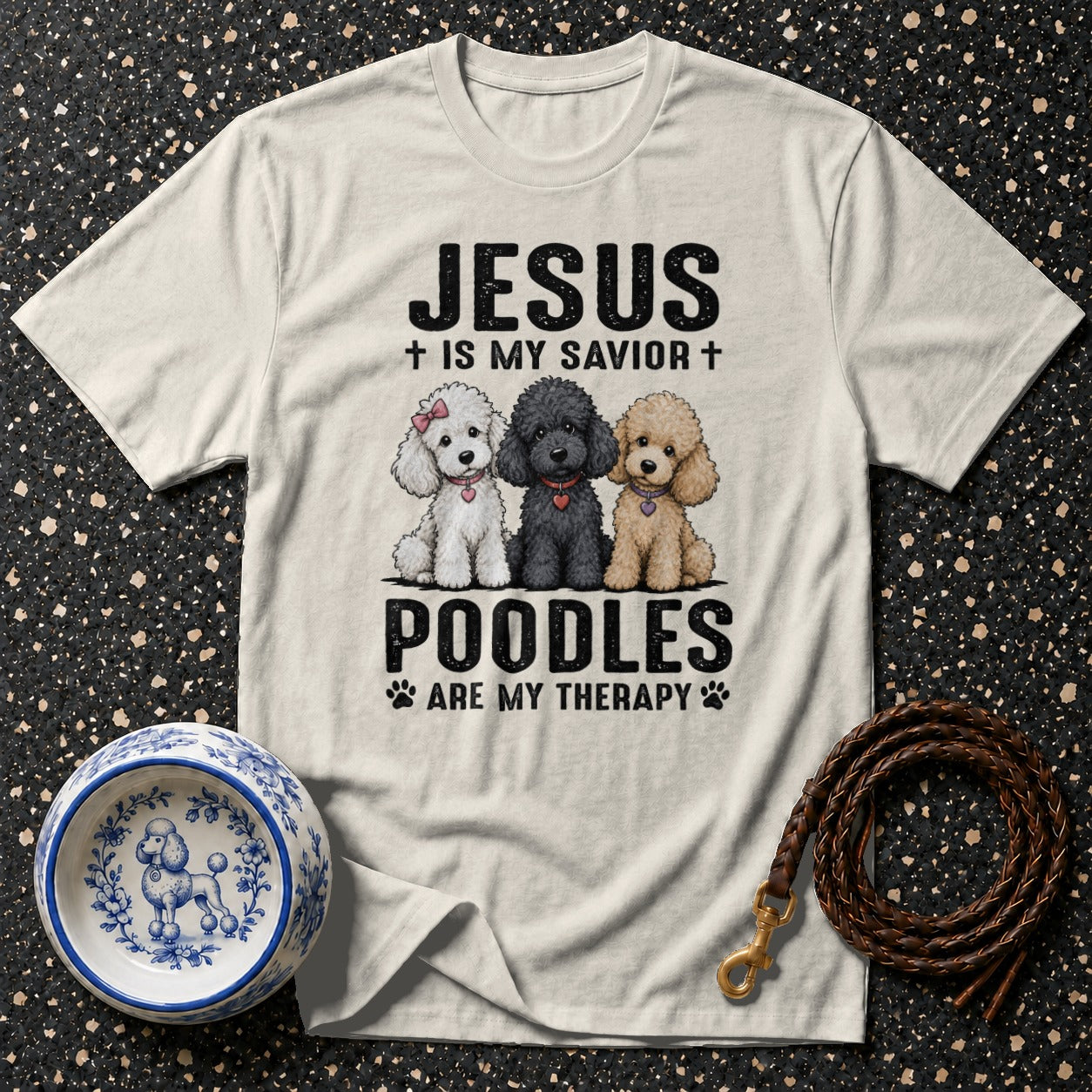 A T-shirt with text "Jesus is my savior" and three poodles.