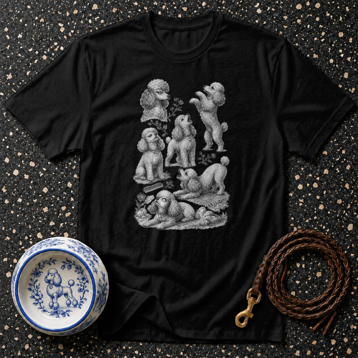 Black t-shirt featuring vintage poodle illustrations and botanical elements.