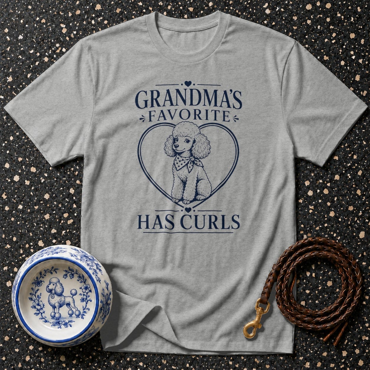Gray t-shirt with navy blue text and poodle graphic: "GRANDMA'S FAVORITE HAS CURLS"