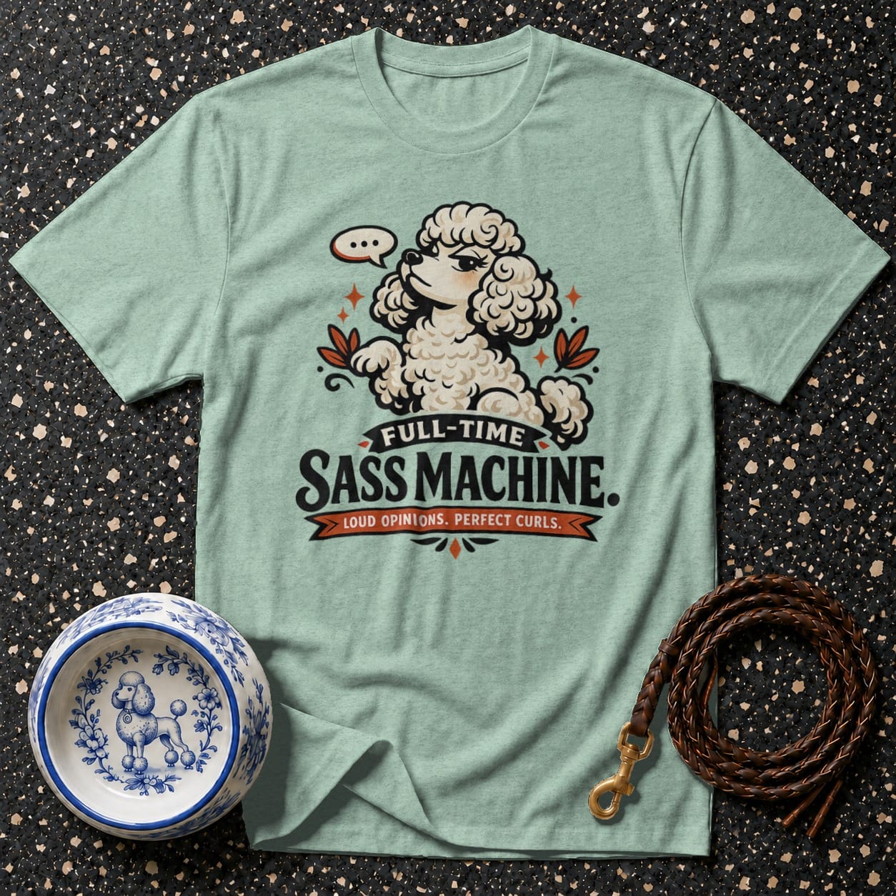 Light green t-shirt with cartoon poodle graphic and text "FULL-TIME SASS MACHINE. LOUD OPINIONS. PERFECT CURLS."
