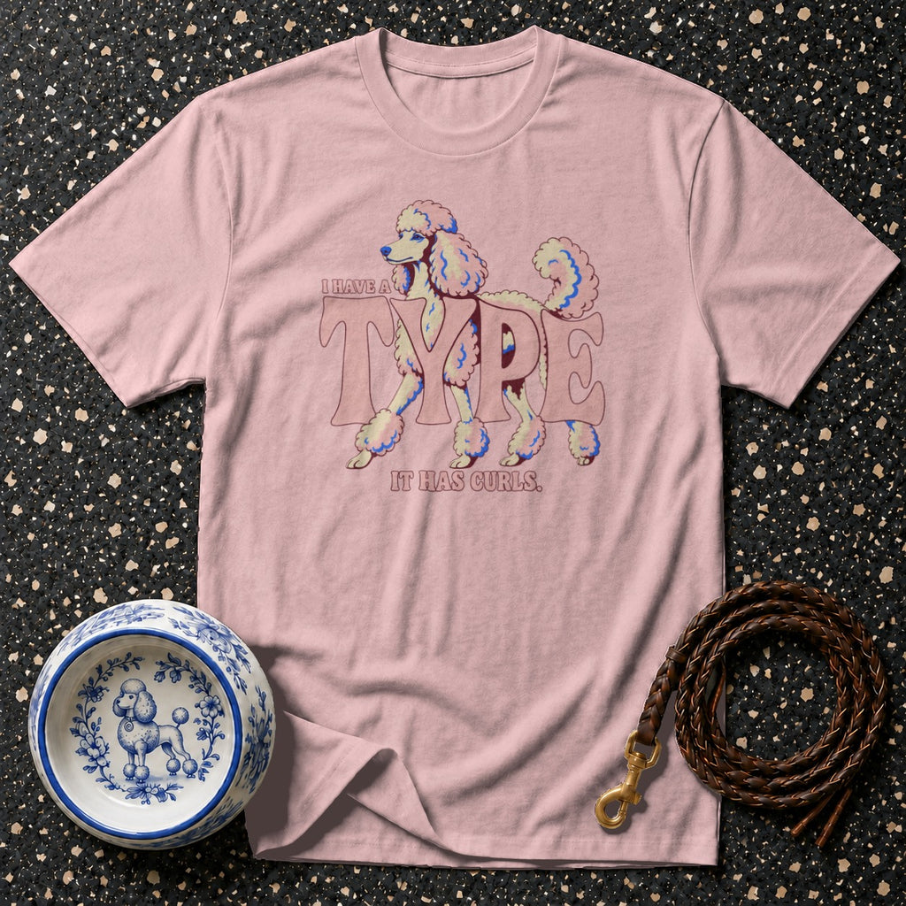 Pink t-shirt with poodle graphic and text "I HAVE A TYPE IT HAS CURLS."