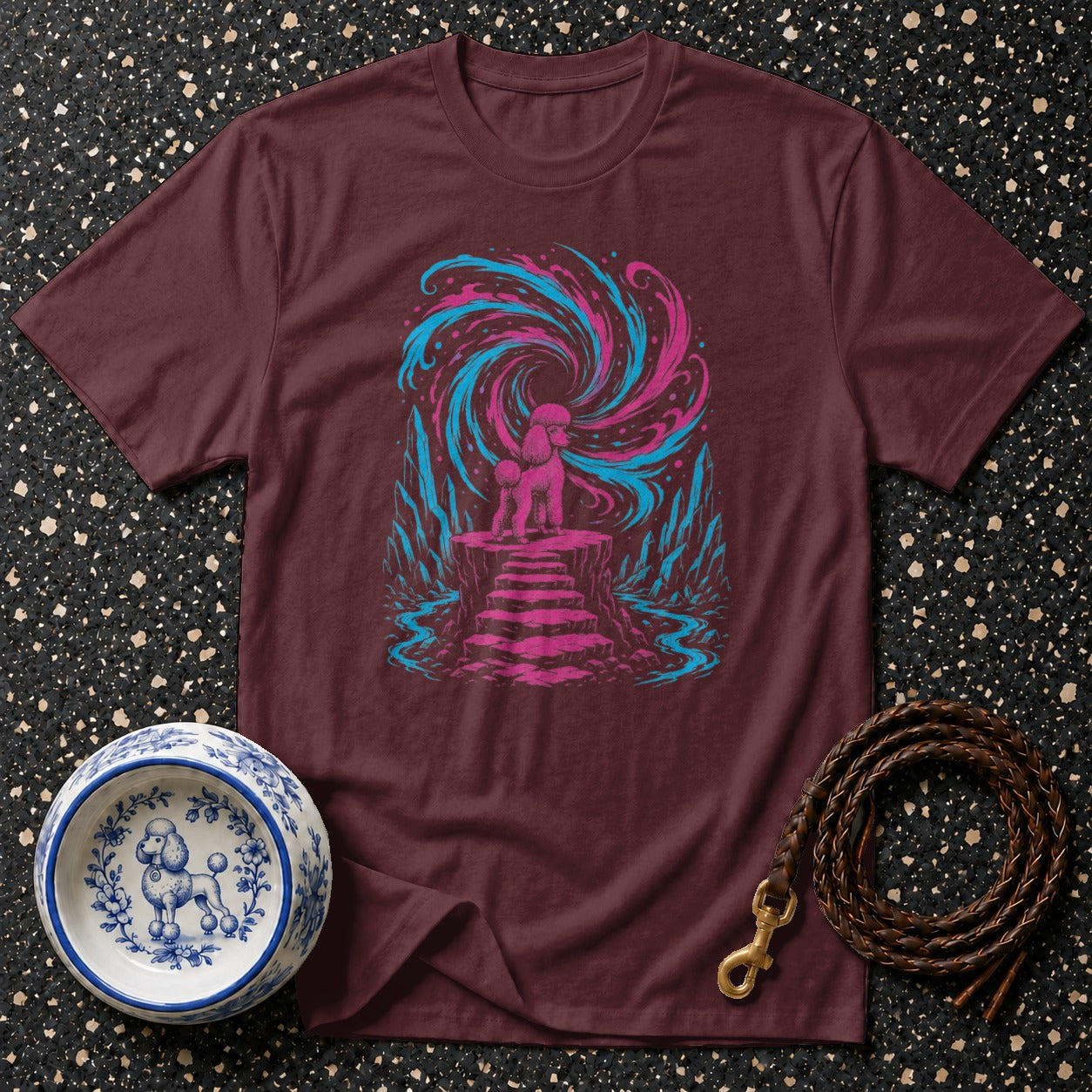 Maroon t-shirt with graphic of a pink poodle standing on steps before a swirling pink and blue vortex.