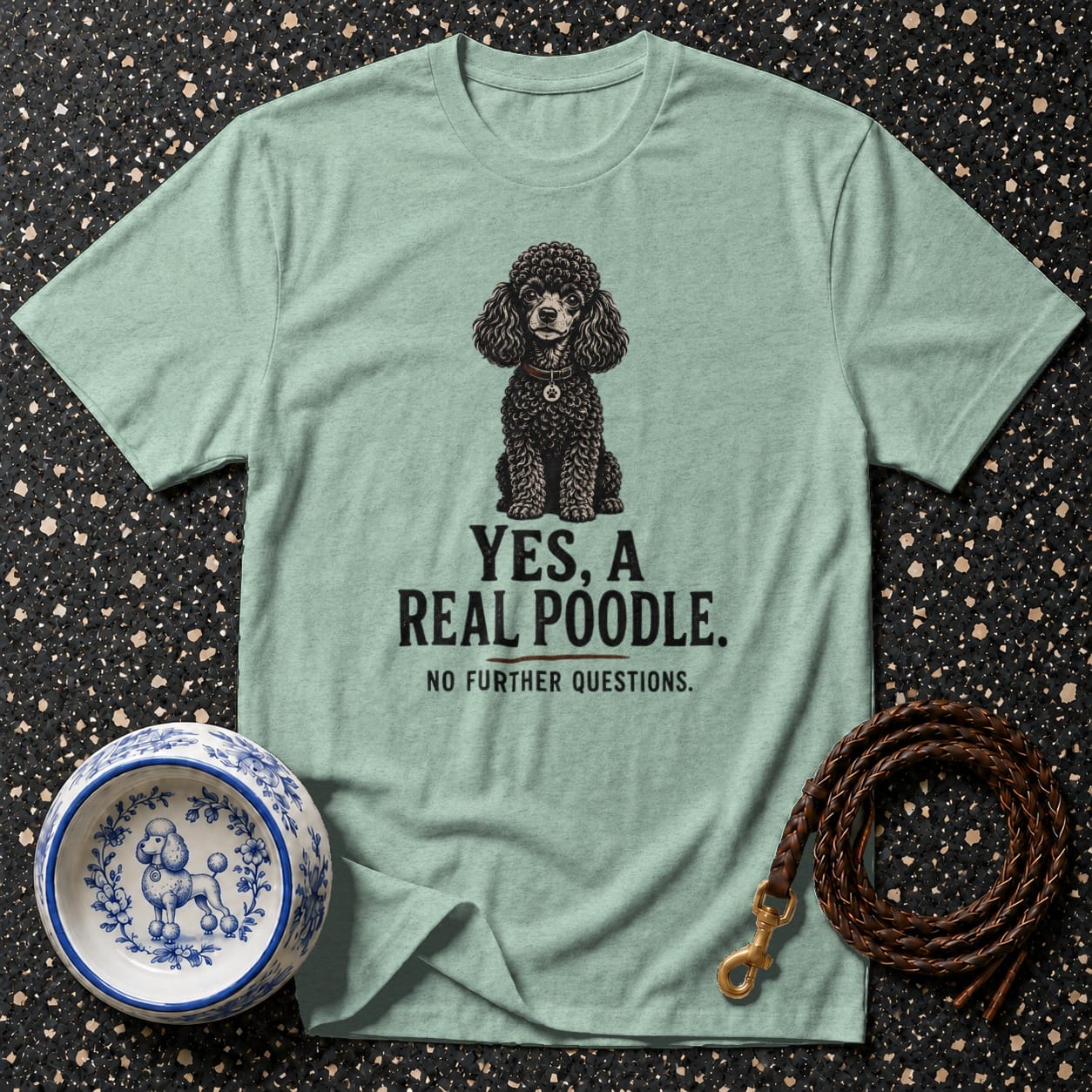 Light green t-shirt with a black poodle illustration and text reading "YES, A REAL POODLE."