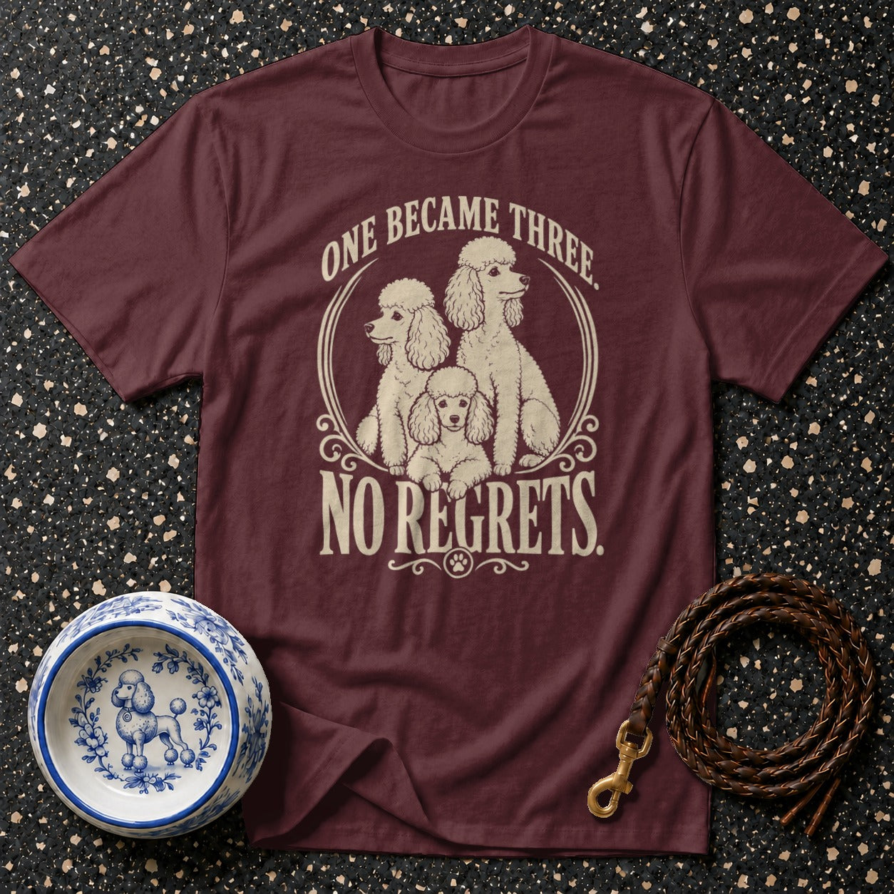 Maroon t-shirt with three poodles and text "ONE BECAME THREE. NO REGRETS."