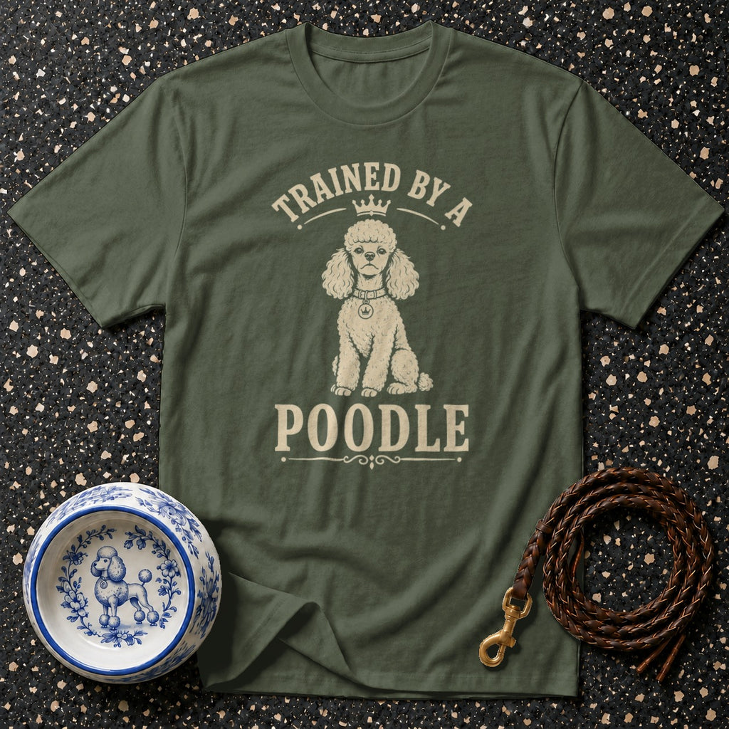 Green t-shirt with a poodle illustration and text that reads "Trained by a Poodle".