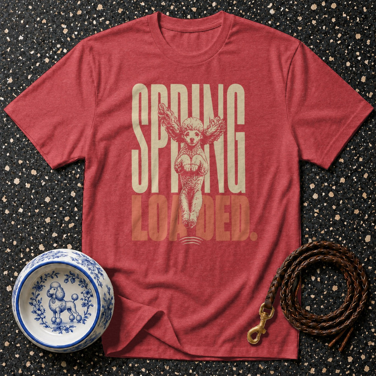 Red t-shirt with "SPRING LOADED" text and winged poodle graphic.