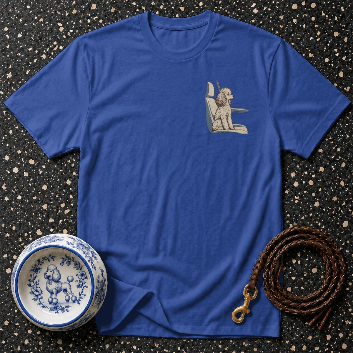 Blue t-shirt with embroidered poodle in car seat, ceramic dog bowl, leather leash.
