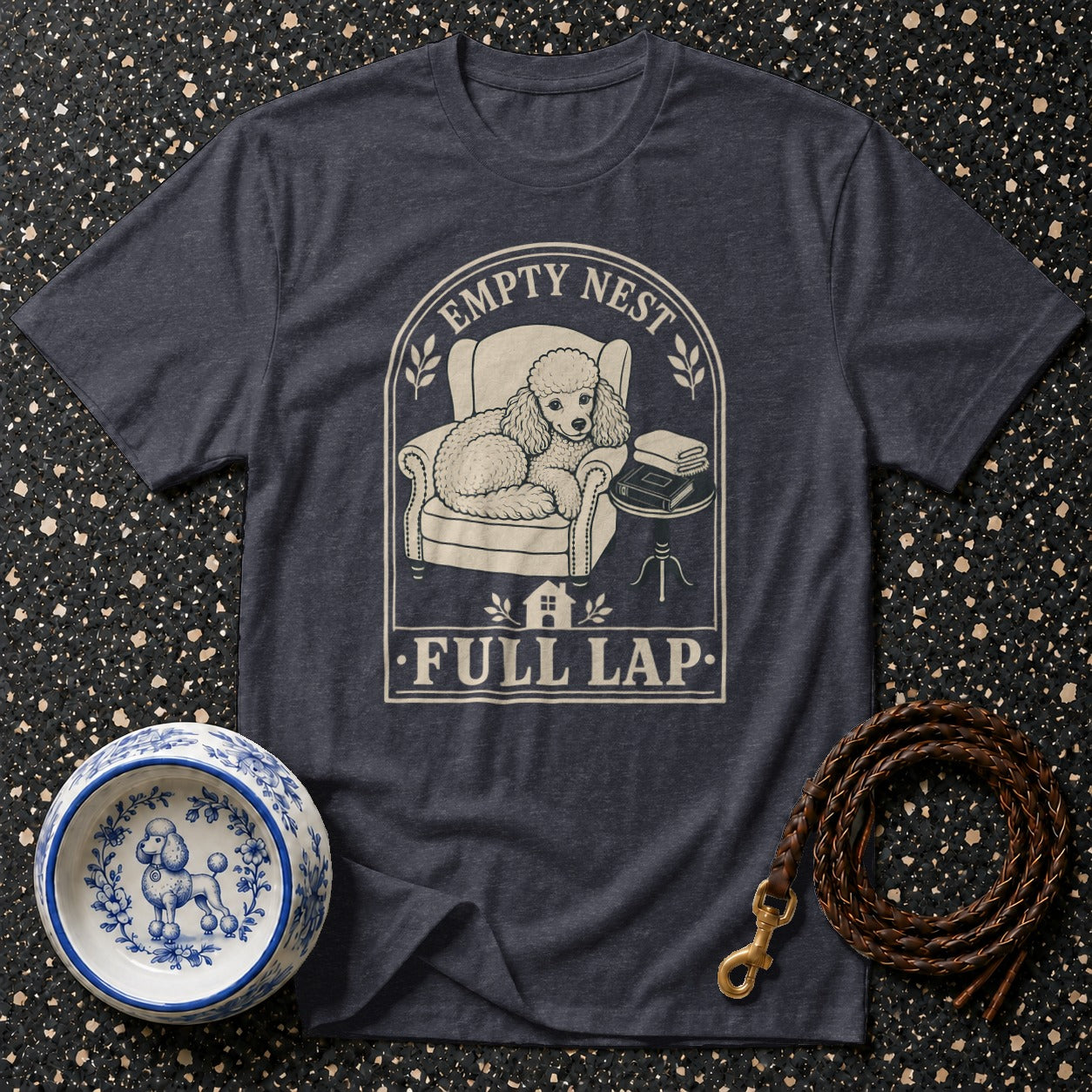 Dark t-shirt with poodle on chair graphic: "Empty Nest, Full Lap".