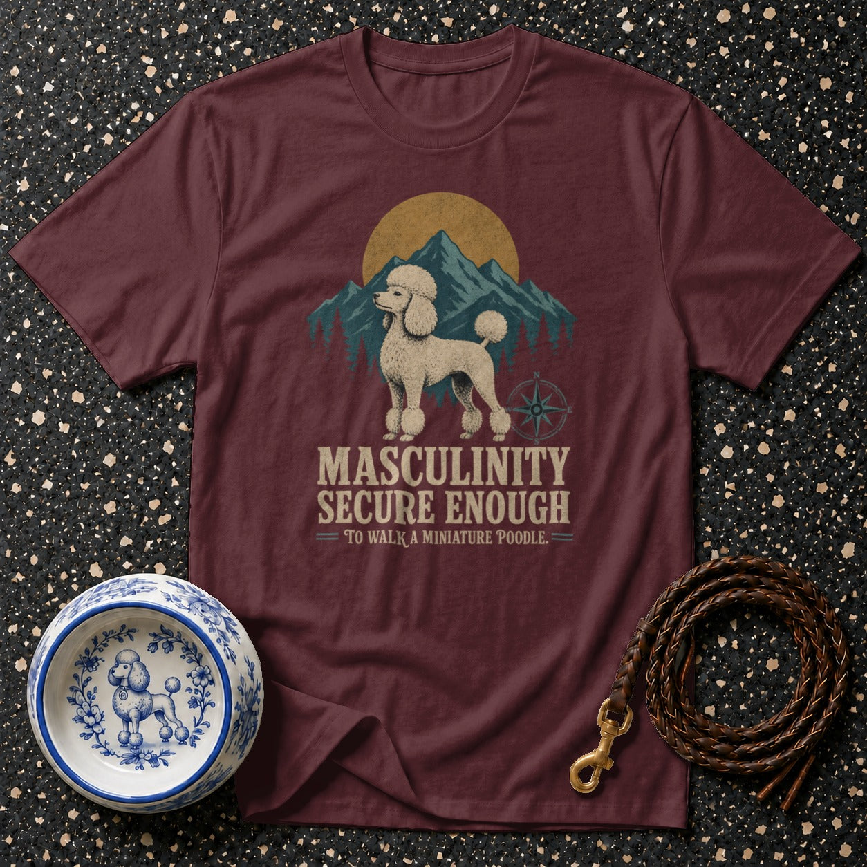 Maroon t-shirt with a miniature poodle graphic and text "MASCULINITY SECURE ENOUGH TO WALK A MINIATURE POODLE".