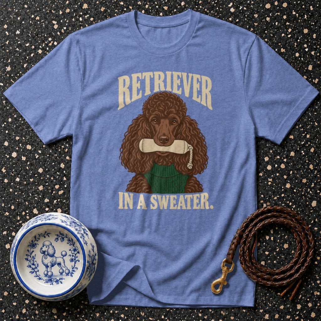 Blue t-shirt with a brown poodle graphic wearing a green sweater and holding a chew toy.