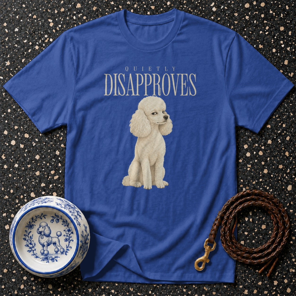 Blue t-shirt with a poodle graphic and "QUIETLY DISAPPROVES" text.