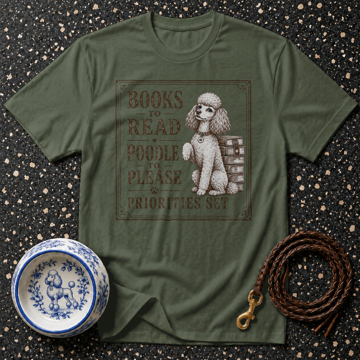 Green t-shirt with a poodle, books, and the text "Books to read, poodle to please, priorities set."