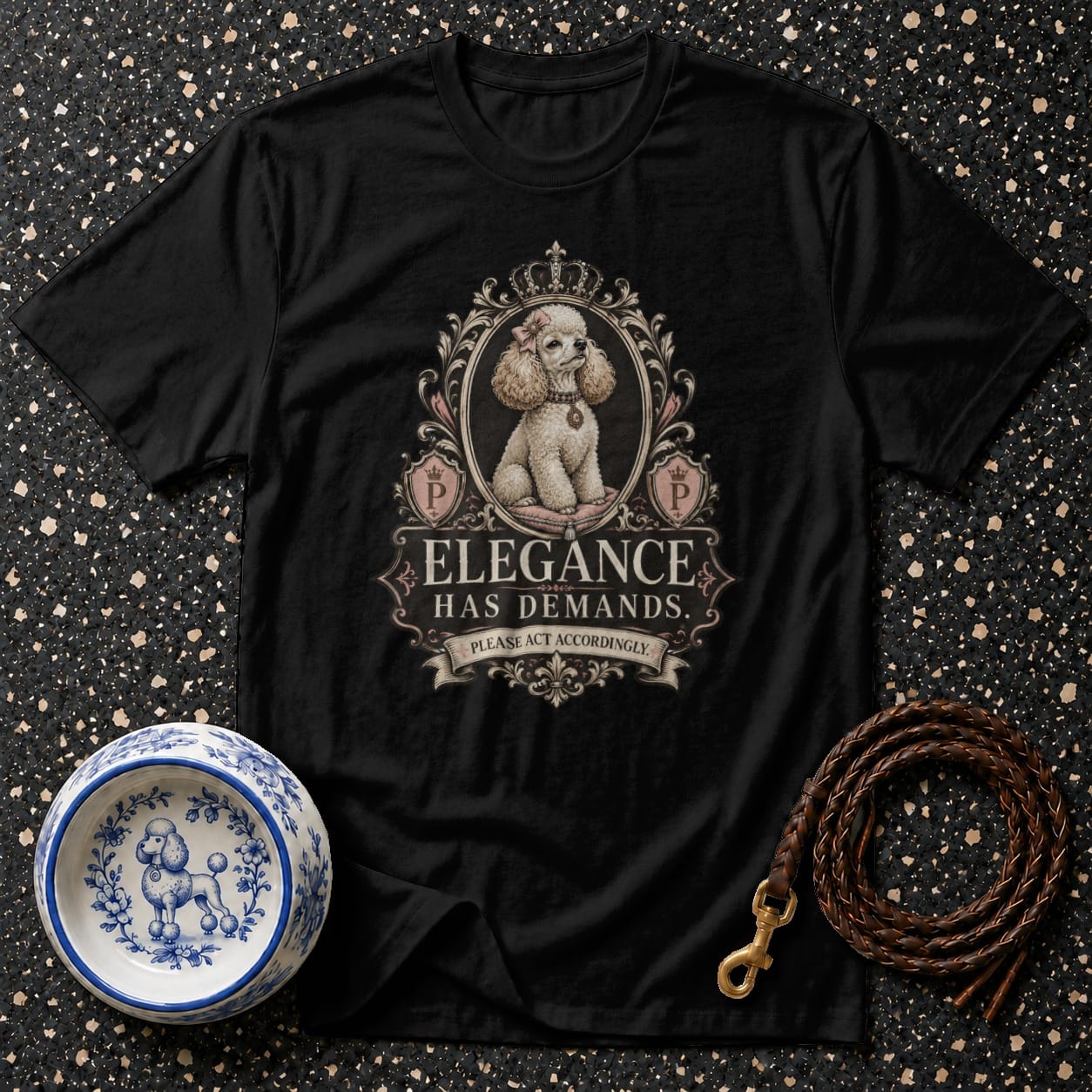 Black t-shirt featuring a poodle in a decorative frame with the text "Elegance Has Demands."