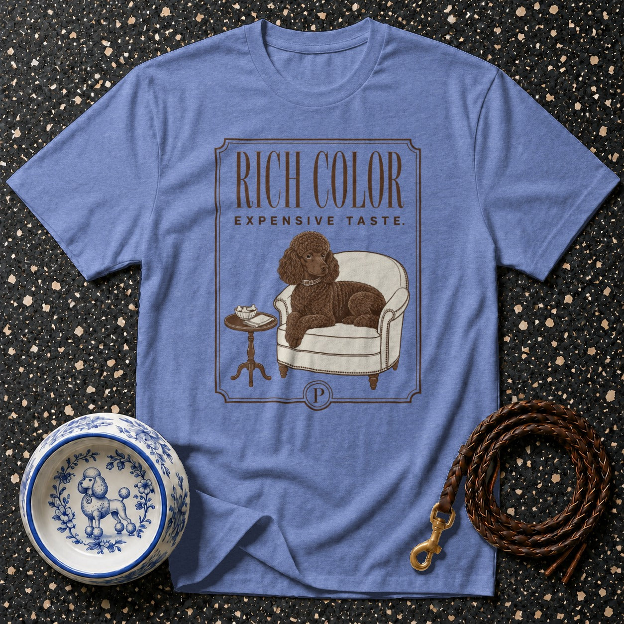 Blue t-shirt with brown poodle illustration; reads "RICH COLOR EXPENSIVE TASTE."