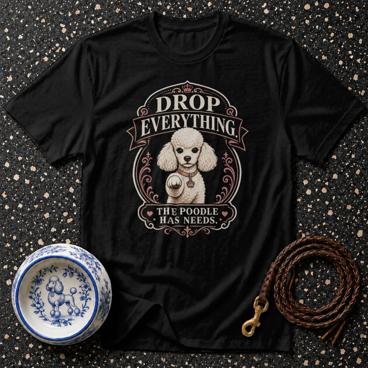 Black t-shirt with "Drop Everything The Poodle Has Needs" graphic.