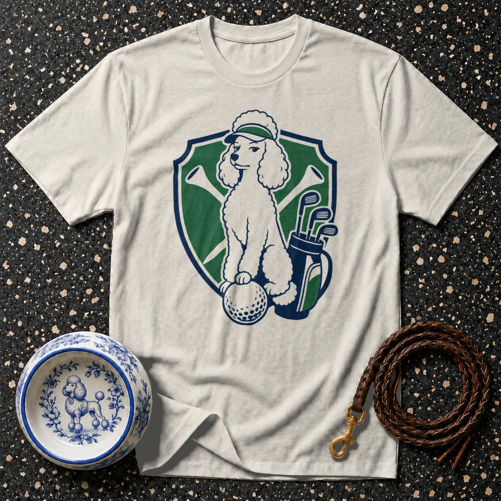 White t-shirt with a graphic of a poodle on a golf ball, holding a golf club.