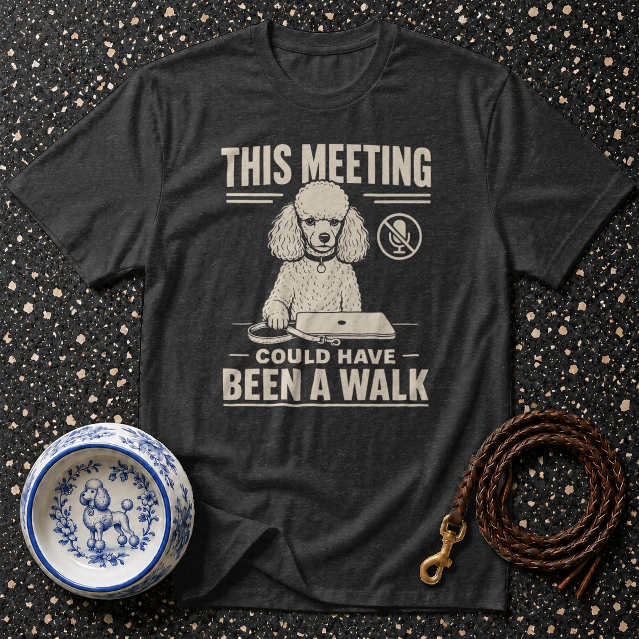 T-shirt with poodle graphic, text "THIS MEETING COULD HAVE BEEN A WALK", dog bowl, and leash.