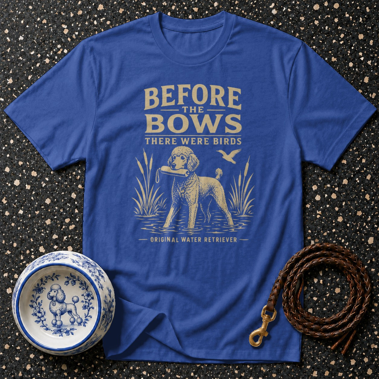 Blue t-shirt with gold text and graphic of a poodle retrieving a dummy.