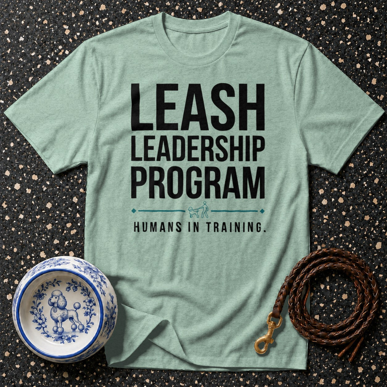 Light blue t-shirt with black text "LEASH LEADERSHIP PROGRAM HUMANS IN TRAINING."