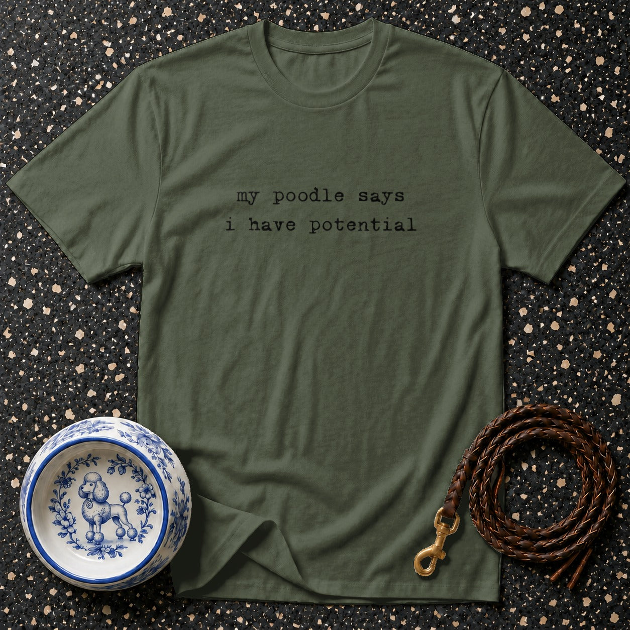Olive green t-shirt with black text reading "my poodle says i have potential."