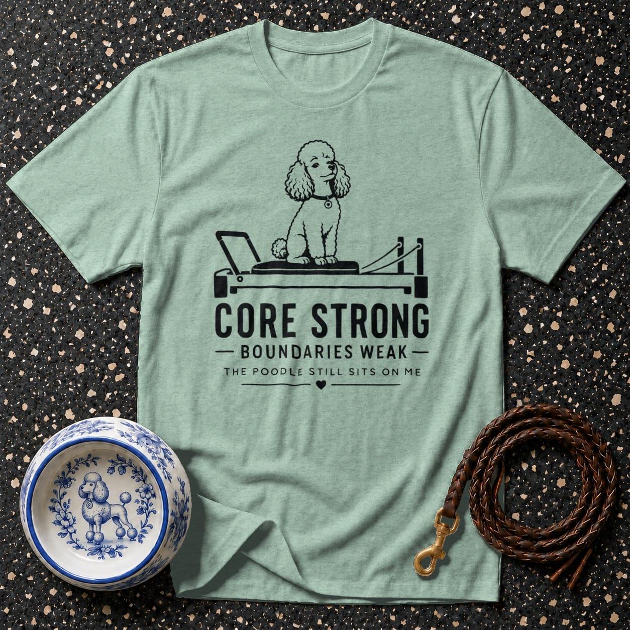 Light green t-shirt with "Core Strong Boundaries Weak" text and poodle on reformer.