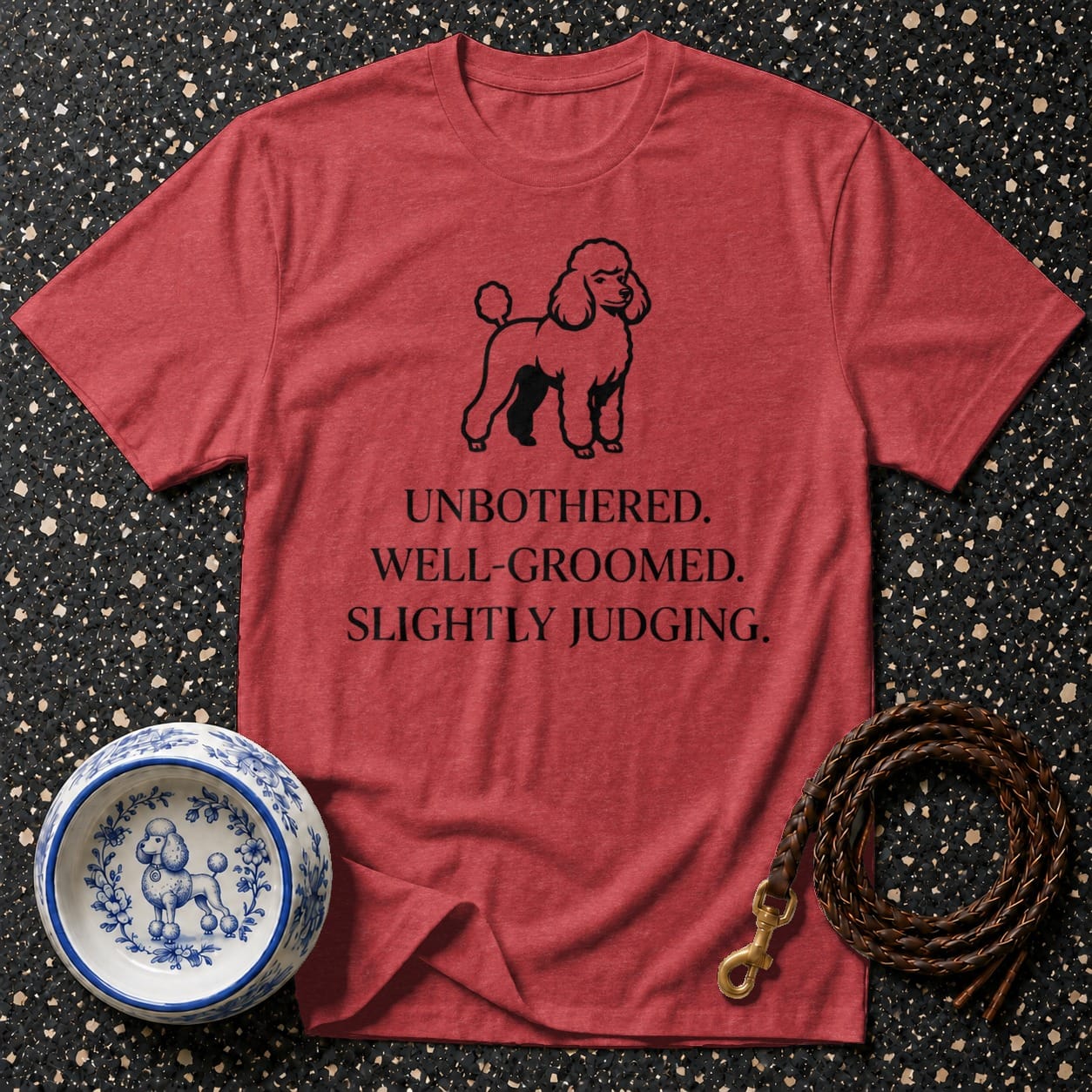 Red t-shirt with a poodle graphic and "Unbothered. Well-Groomed. Slightly Judging." text.