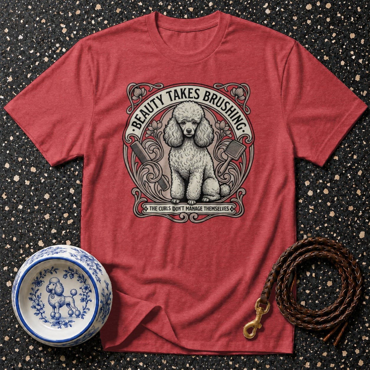 Red t-shirt with an illustration of a poodle and grooming tools, reads "Beauty Takes Brushing" and "The Curls Don't Manage Themselves".