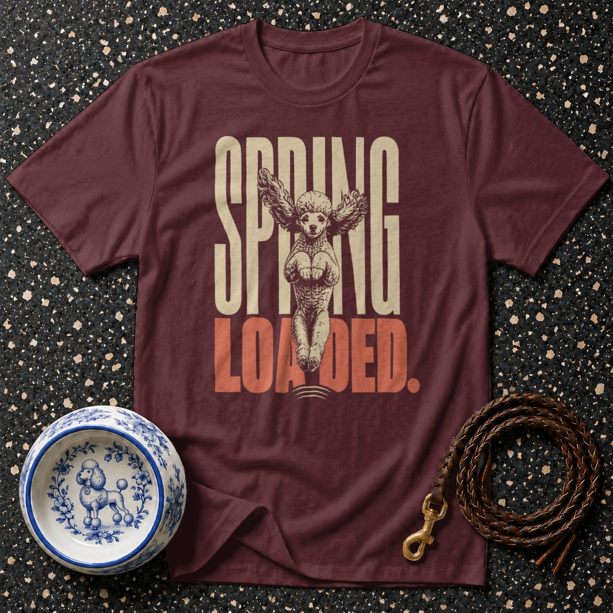 Maroon t-shirt with "SPRING LOADED" text and a poodle with wings.