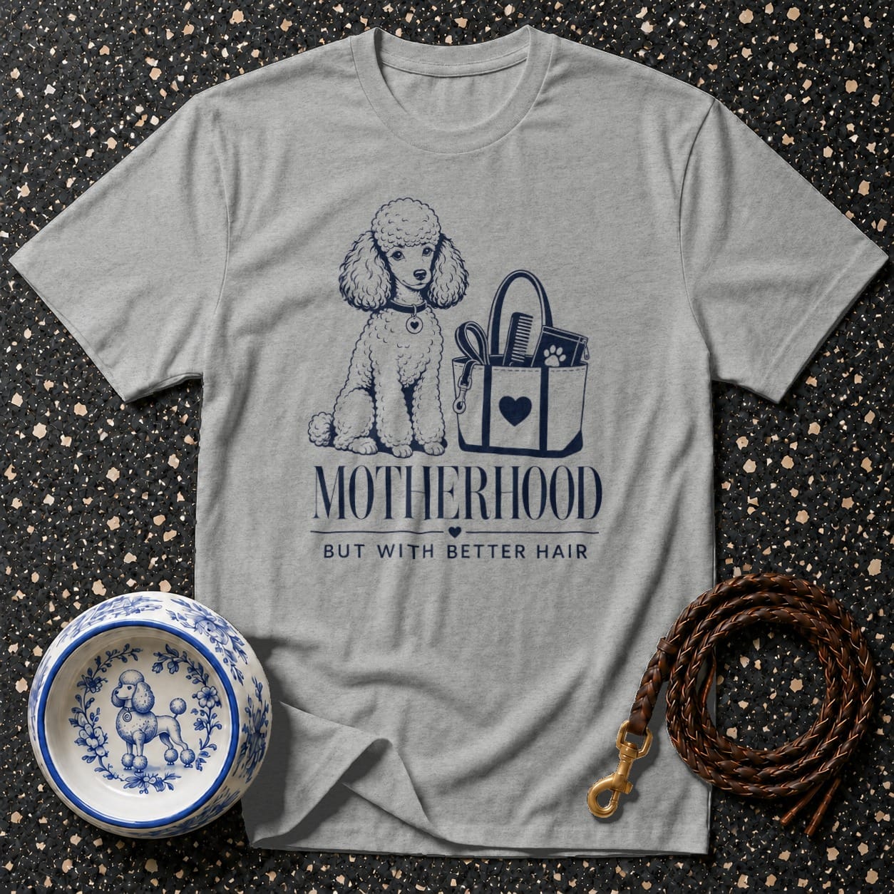 Grey t-shirt with poodle graphic reads "Motherhood But With Better Hair".