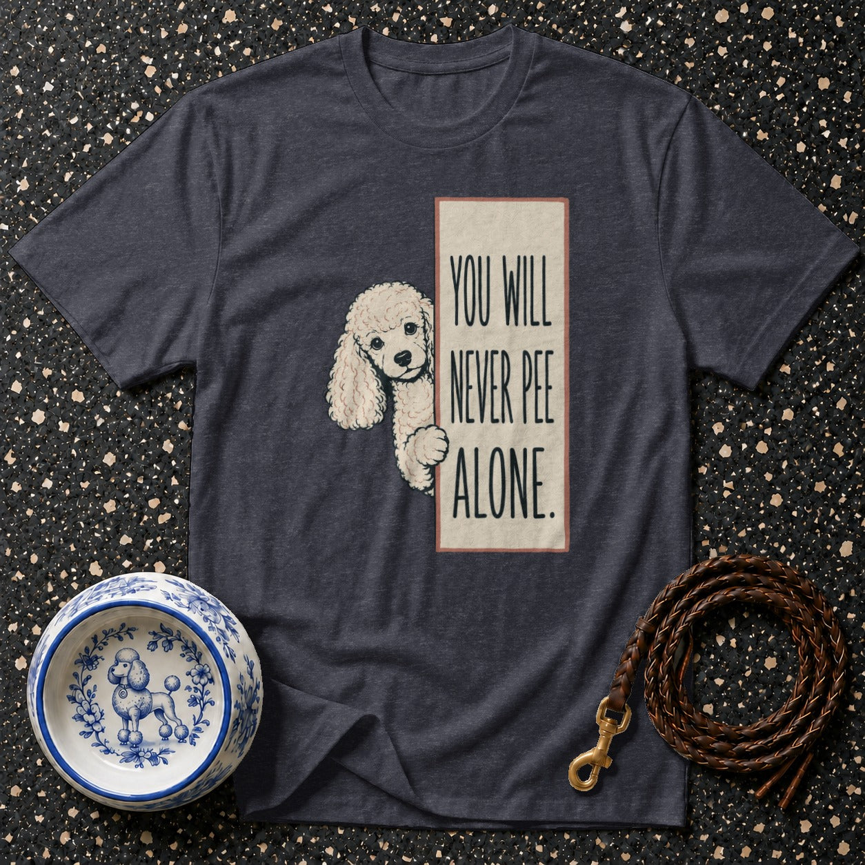 Dark gray t-shirt with a poodle graphic and the text "YOU WILL NEVER PEE ALONE."