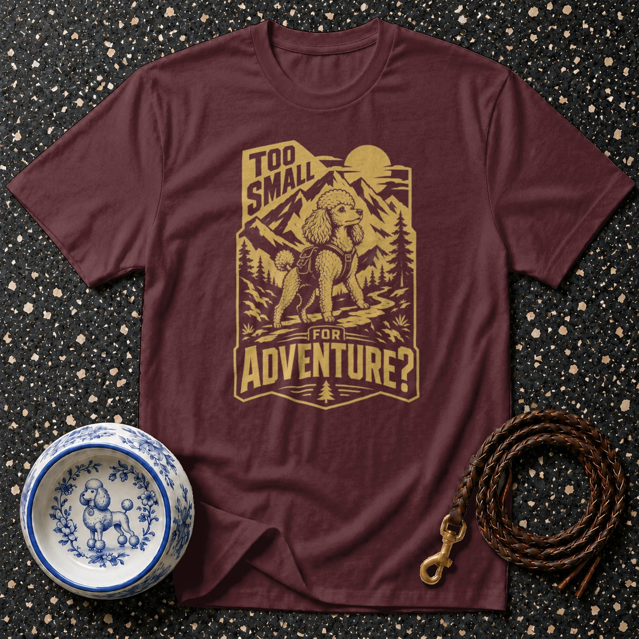 Maroon t-shirt with a poodle in mountains design and text "Too small for adventure?".