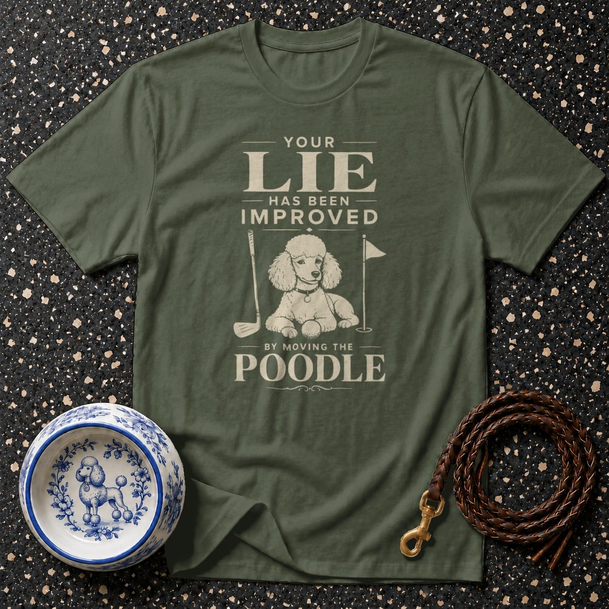 Olive t-shirt with text and poodle graphic, golf club, and golf flag.