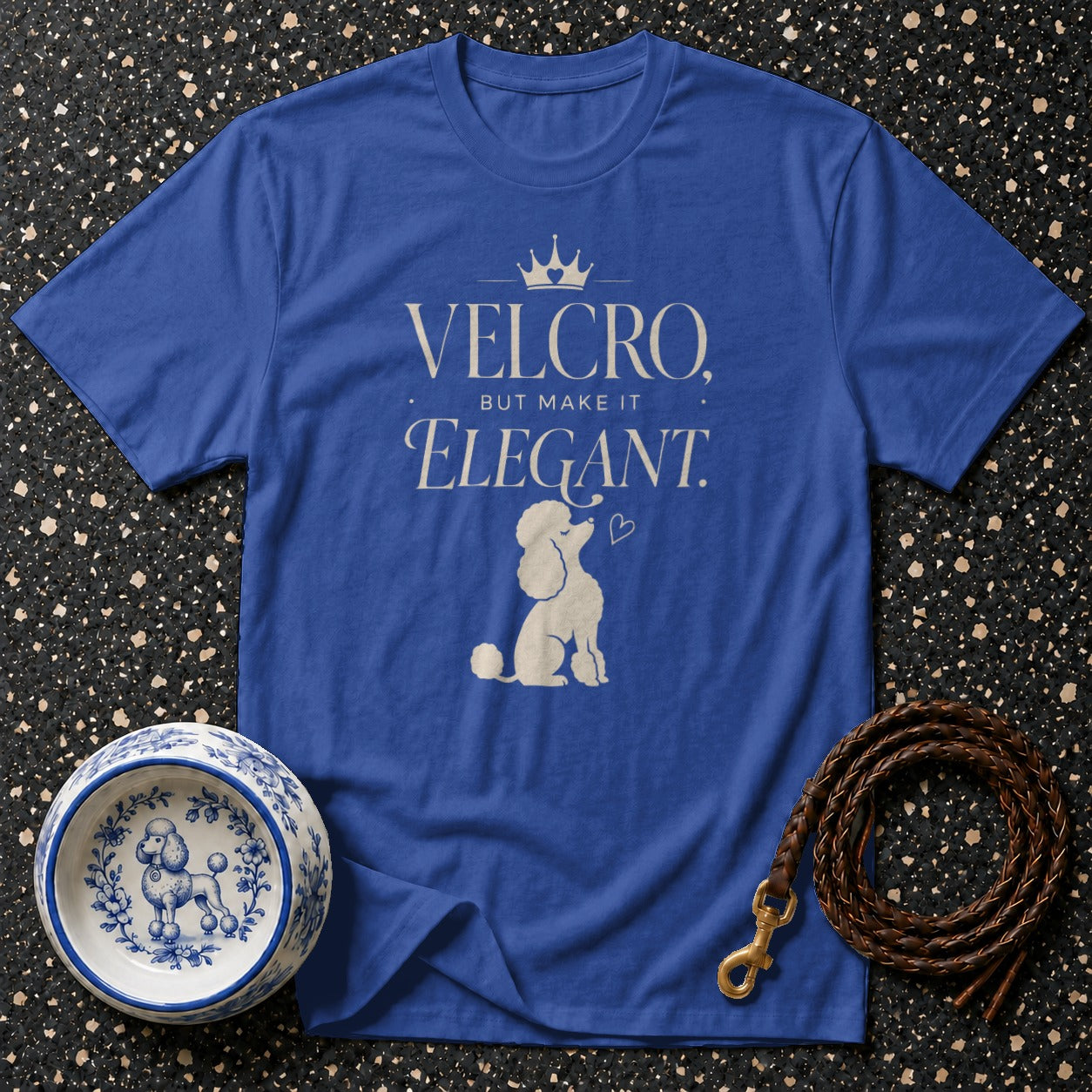 Blue t-shirt with "Velcro, but make it Elegant" and a poodle graphic.