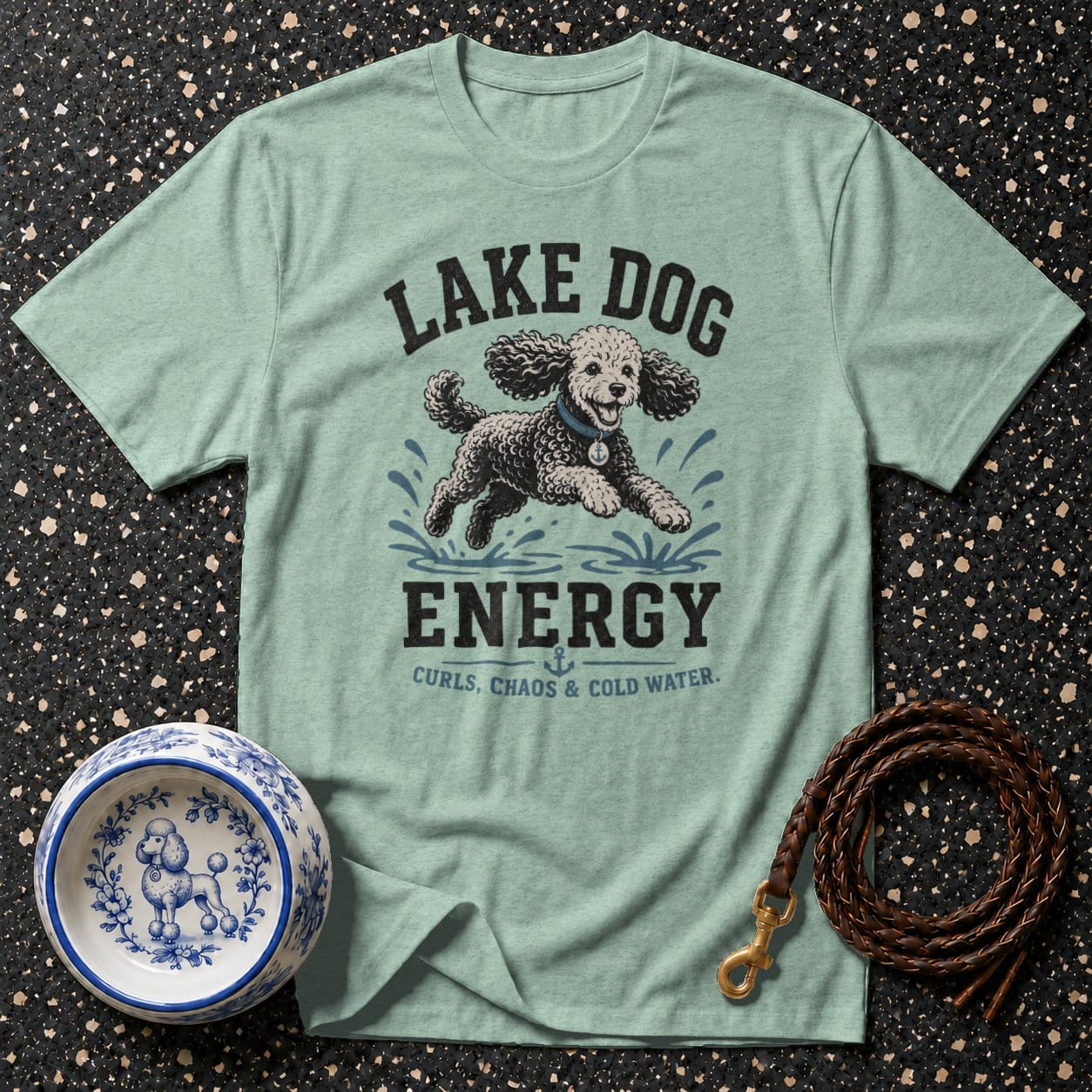 Light blue t-shirt with graphic: "LAKE DOG ENERGY CURLS, CHAOS & COLD WATER."