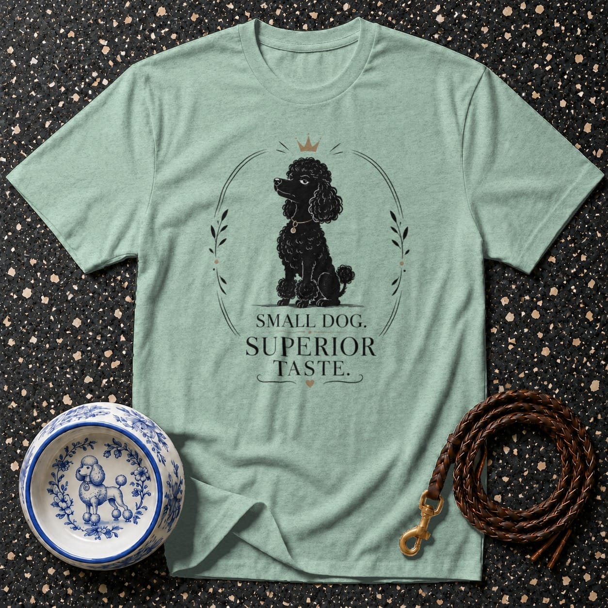 Light green t-shirt with a black poodle design and text "Small Dog. Superior Taste."
