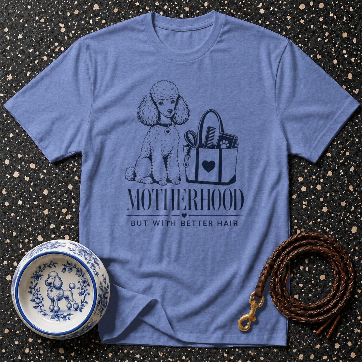 Blue t-shirt with a poodle, grooming bag, and text "Motherhood But With Better Hair".