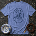 Blue t-shirt with oval graphic of poodle golfer and text "EMOTIONAL SUPPORT CADDIE".