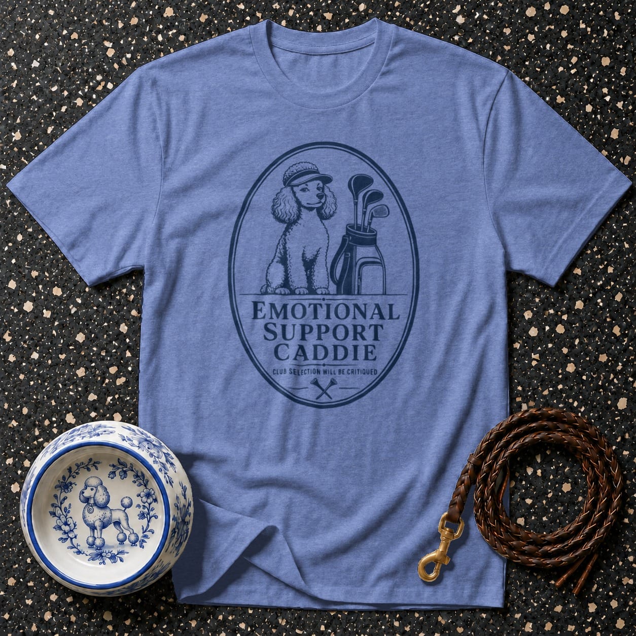 Blue t-shirt with oval graphic of poodle golfer and text "EMOTIONAL SUPPORT CADDIE".