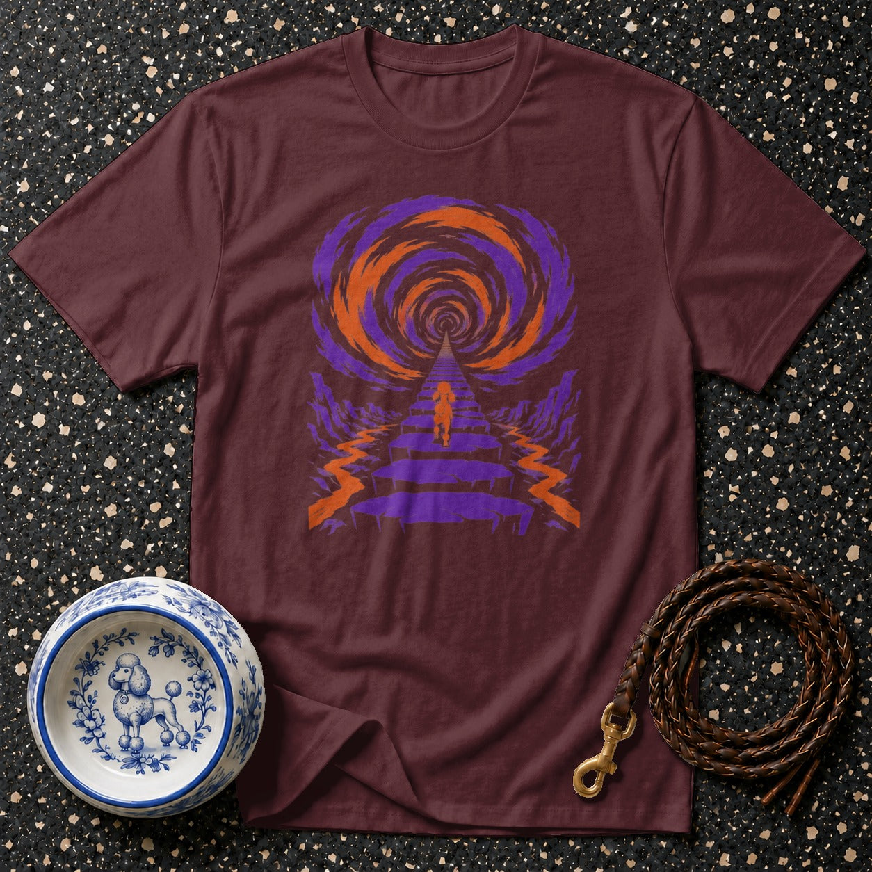 Maroon t-shirt with abstract orange and purple psychedelic tunnel graphic.
